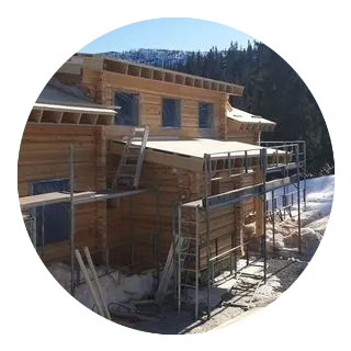 A timber extension under construction in the snow