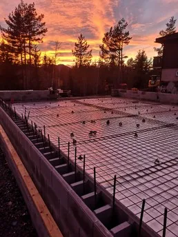Insulated foundation forms under a red evening sky