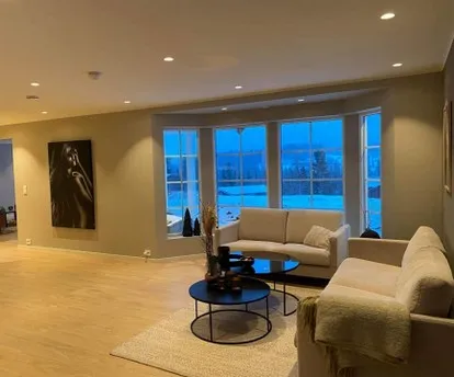 A finished living room with large windows